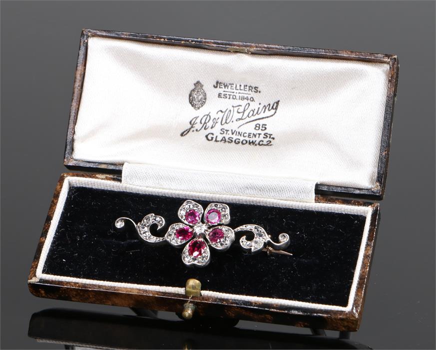 Ruby and diamond brooch, the flower head set with a central diamond and ruby petals with further