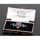 Ruby and diamond brooch, the flower head set with a central diamond and ruby petals with further