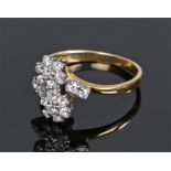 18 carat gold diamond set ring, the cross over ring with flower head design, ring size N