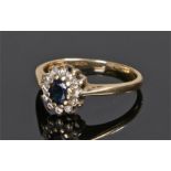 18 carat gold sapphire and diamond ring, the central oval sapphire with diamond surround, ring