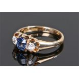 18 carat gold sapphire and diamond set ring, the central sapphire with a diamond to either side,