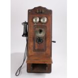 American Electric Tel. Co. wooden cased wall mounted telephone, with mouth piece to the left hand