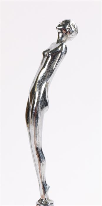 Chrome car mascot, in the form of a female nude with her hands clasped behind her back, 18cm high