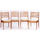 Set of four mid 20th century style teak dining chairs, with pierced curved splat backs, over stuffed