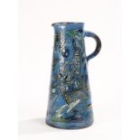 Ch Brannam Barnstaple Pottery jug, the tapering blue body with fish and weed decoration, loop