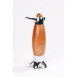 Peugeot pepper mill, the teak cap above a chrome side handle, teak bulbous body, on a chrome foot,