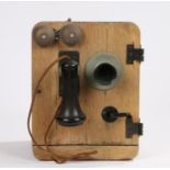 Kellogg wooden cased wall mounted telephone, with bakelite mouthpiece, the case with two bells,