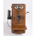 Kellogg wooden cased wall mounted telephone circa 1910, with mouth piece to the left hand side,