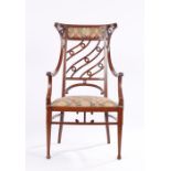 Unusual late 19th Century mahogany and boxwood strung armchair, the arched pad back top rail with