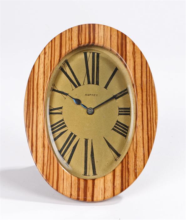 Asprey desk clock, the signed gilt dial with roman numerals, housed in an olive wood and brass