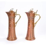 Pair of W.M.F. claret jugs in copper and brass, decorated with a band of stylised fruiting trees