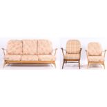 Ercol blonde three seat settee and matching armchair, with floral upholstered cushions, similar