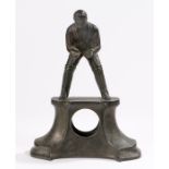 Metal mantel clock case, cast with a depiction of a cricket wicket keeper, on an out splayed base,