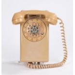 Stromberg-Carlson wall mounted dial telephone with peach coloured outer case and handset