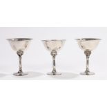 Three Georg Jensen Danish sterling silver goblets, with beaten bowls, bead decorated wasted stems,