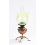 In the style of W.A.S. Benson, a brass & copper oil lamp, with vaseline glass shade, the lamp