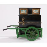 Model barrel organ with ebonised case, on a green painted cart, 21.5cm wide, 17.5cm high