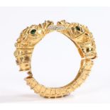 Kenneth Jay Lane gilt metal bracelet, decorated with two horses heads biting a paste set ring,