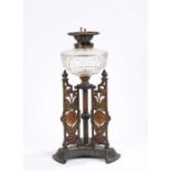 Youngs Duplex oil lamp, with clear glass reservoir, the cast base with urn form finials and