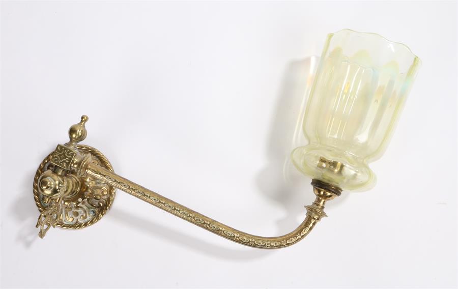 Vaseline glass wall light, with a gilt metal fitting and long curved arm to the Vaseline glass