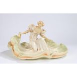 Art Nouveau pottery figure depicting a lady wearing a flowing dress with her arms outstretched, 41cm