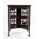 Edwardian mahogany revolving bookcase, in the style of Liberty, the top with canted corners, the