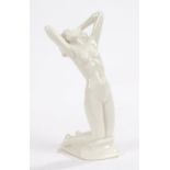 Blanc de chine porcelain figure of a kneeling female nude on a rocky outcrop, made for
