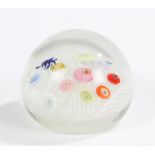 Glass paperweight, inset with eleven millefiori canes on a swirled white base