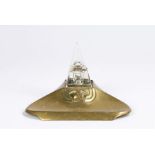 1930's brass desk stand, with pyramid form glass inkwell above a brass base with stylised animal