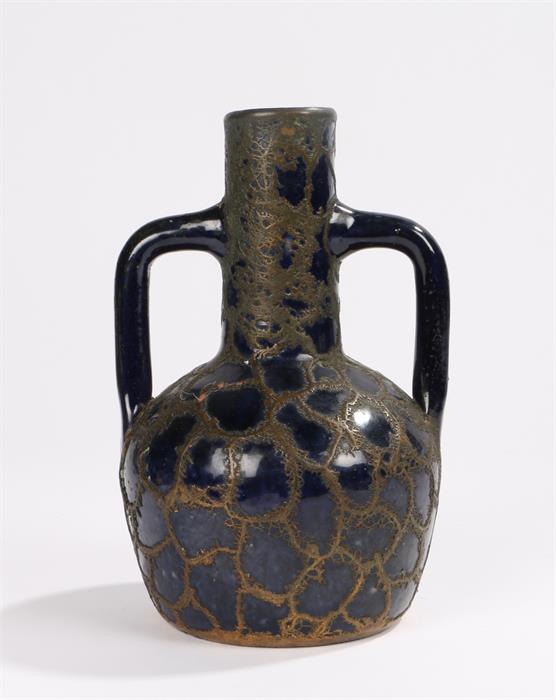 Blue pottery twin handled vase, with overlaid copper decoration, 18.5cm high