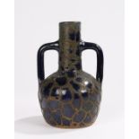 Blue pottery twin handled vase, with overlaid copper decoration, 18.5cm high