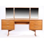 Austinsuite teak dressing table, with triple mirror above a fitted kneehole drawer and three drawers