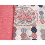 20th century needlework quilt formed from hexagonal panels surrounded by a floral border, together