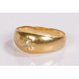 18 carat gold diamond set ring, the round cut diamond set within a star mount, tapering shank,