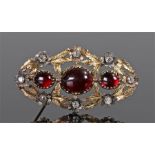 Victorian garnet and diamond set brooch, the cabochon trio of garnets with eight diamonds set to