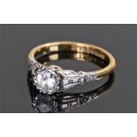 18 carat gold stone set ring, the central clear stone with shaped shoulders, ring size M