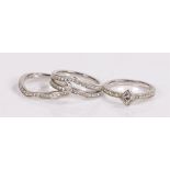 Three rings, in white metal, housed within a Pandora box, (4)