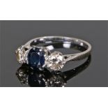 Sapphire and diamond ring, with a central sapphire flanked by a round cut diamond to either