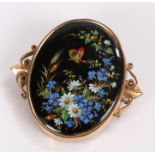 Yellow metal and enamel brooch, with a central panel decorated with flowers and a butterfly, 35mm