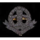 World War Two plastic economy cap badge to the Middlesex Regiment, in chocolate brown, two blades to