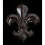 World War Two plastic economy cap badge to the Manchester Regiment, in chocolate brown, two blades