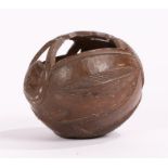 19th century carved coconut bugbear, with a fret carved top above the face to the front and