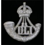 World War Two plastic economy cap badge to the Durham Light Infantry, in silver grey, two blades