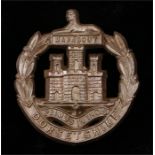 World War Two plastic economy cap badge to the Dorsetshire Regiment, in light bronze, two blades