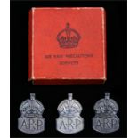 Three silver Air Raid Precautions lapel badges, all London 1938, maker J.C., contained in a red