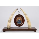 Fine 19th Century scrimshaw walrus tusk picture stand, the front of the tusks decorated with rope