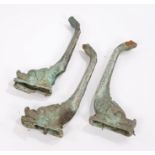 Three dolphin console table legs, in bronze, bought up from a shipwreck, 62cm high