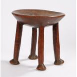 19th Century Shona stool, the dish top above four legs and pad feet, 25cm x 27cm