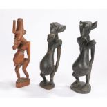 Three Ugandan carved figures, each with large stomachs showing fertility, (3)