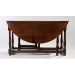 18th Century oak drop leaf table, the drop leaf oval top above a single frieze drawer and turned